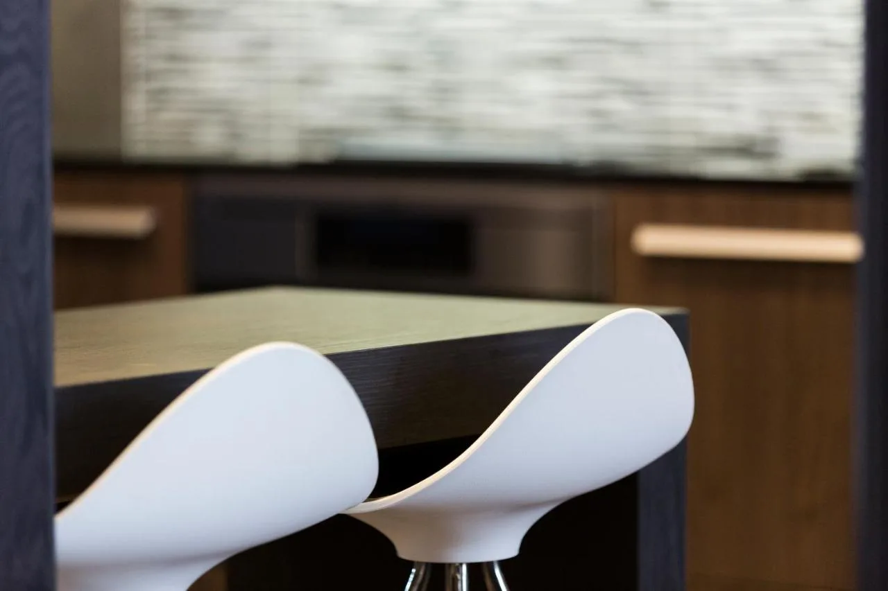 a pair of white chairs sitting at a table at The Westbourne Hyde Park in London