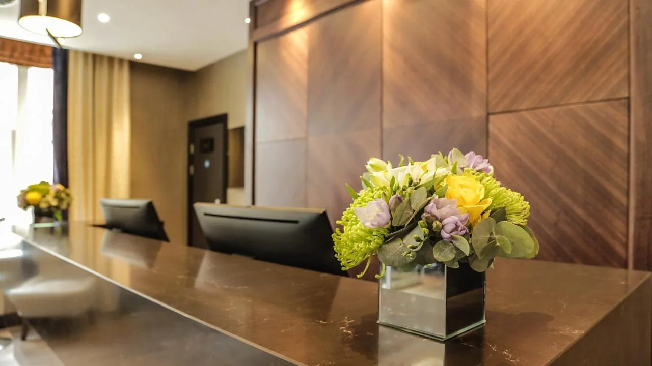 a vase of flowers on a table in a lobby at The Westbourne Hyde Park in London