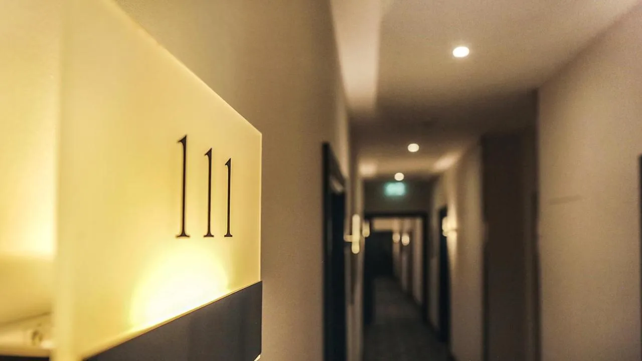 a hallway with a row of lights on a wall at The Westbourne Hyde Park in London